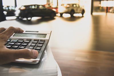 person calculating total loss formula on calculator